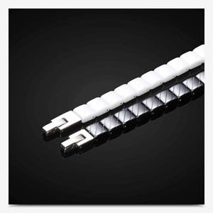Detail of 7mm black and white ceramic links with a diamond-cut texture and metal clasps