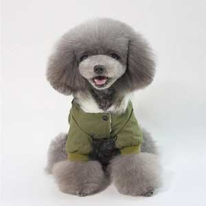 Detail of army green dog jacket featuring white faux fur collar and ribbed cuffs for winter
