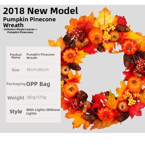 Detail showing artificial maple leaves, pine cones, and mini pumpkins on a 45cm autumn wreath
