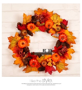 Detailed close-up of autumn maple leaves, pumpkin, and pine cones on a festive wreath