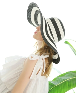 Macro detail of wide-brim straw sun hat with black and white stripes for summer vacation