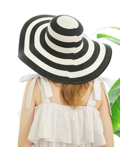 Detail of wide brim straw hat with black and white stripes for summer sun protection