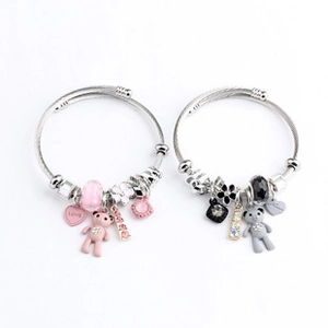 Detail of pink and grey beaded bear charm bracelets with heart and flower pendants