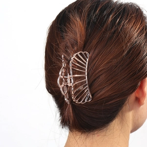 Rose gold shell claw clip in hollow design shown on model for stylish hair styling