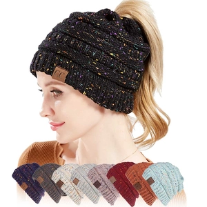 Detail of multi-color confetti knit ponytail beanie with a C.C brand leather patch