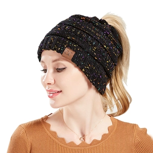 Detail of multi-color knit beanie with ponytail hole and brown leather logo patch