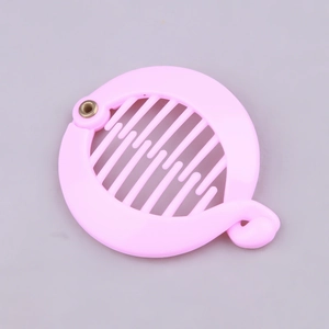 Detailed top view of pink plastic round hair banana clip with teeth and metal hinge