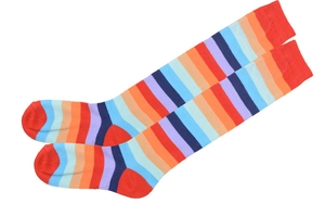 Macro detail of rainbow striped mid-calf socks with red heel and toe contrast