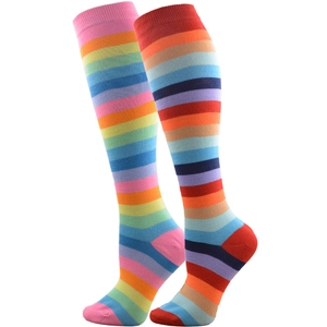 Detail of colorful rainbow striped knee high socks with asymmetric pink and red heels