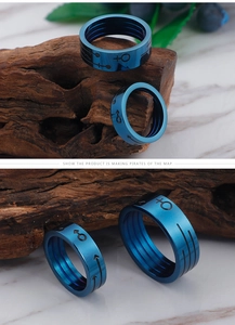 Detailed macro view of blue titanium steel rings with male and female symbol engravings