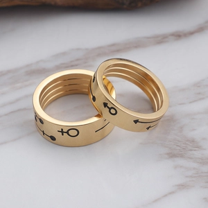 Titanium steel couple rings in gold finish featuring male and female gender symbols