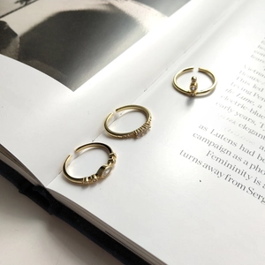 Three adjustable 925 sterling silver gold rings with zircon stones in a stylish group layout