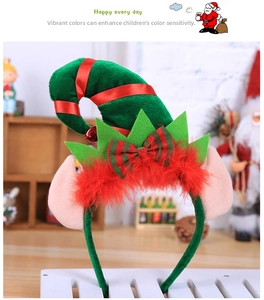 Close-up of a Christmas elf headband featuring green velvet hat and red feather details