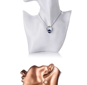 Detail showing blue gemstone necklace and pearl earrings on female bust jewelry displays