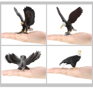 Detailed view of realistic bald eagle and owl models with hand for size comparison