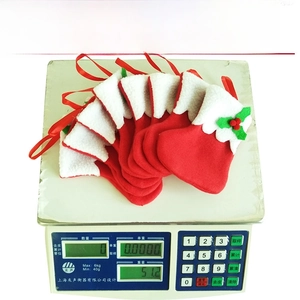 Detailed weight measurement of 10 mini Christmas felt stockings with holly leaf accents