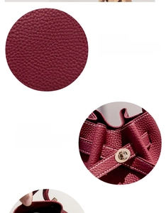 Close-up of litchi pattern leather and gold metal buckle on burgundy bucket bag