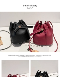 Detail of lychee pattern leather bucket bag with gold lock and drawstring closure