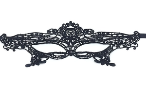 Detailed view of the black lace masquerade mask with intricate hollow-out floral patterns