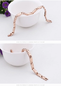 Detail of rose gold titanium magnetic bracelet featuring a fold-over clasp and black magnets