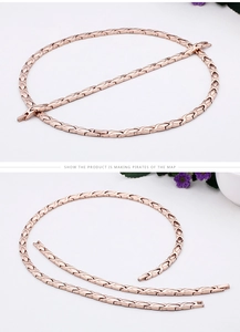Macro detail of rose gold magnetic therapy necklace link chain with floral background