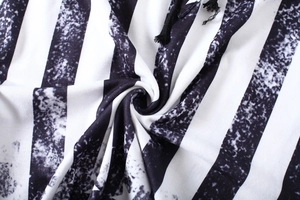 Macro shot of black and white vertical striped fabric with vintage snowflake texture