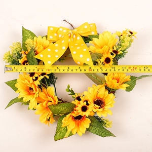 Artificial sunflower wreath with yellow polka dot bow, measured with measuring tape