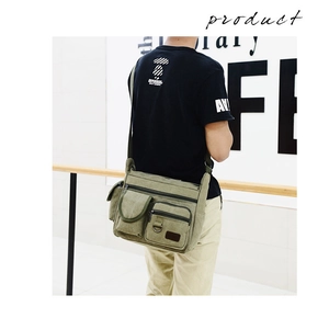 Detail view of army green canvas messenger bag with functional pockets and wide strap