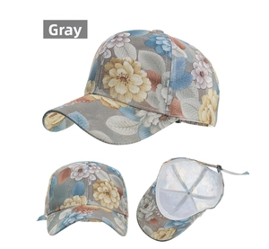 Detail of grey baseball cap featuring floral lace print and metal adjustable buckle