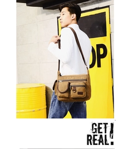 Detail view of khaki canvas crossbody bag with multi-pocket design on male model