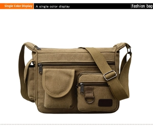 Detail of military green canvas crossbody bag showing heavy-duty texture and zippers