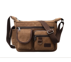 Close-up of brown canvas crossbody bag featuring multi-pocket design and ZETA leather patch