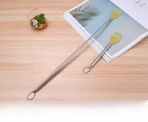 Retractable back scratcher showing collapsed and extended states on a wooden desk