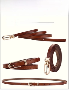 Detail of brown split leather belt with a minimalist golden buckle and fine stitching