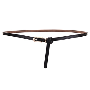 Minimalist black leather skinny belt for women with elegant golden pin buckle on white backdrop