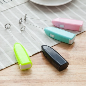 Electric handheld milk frother in pink, blue, black, and green for coffee mixing