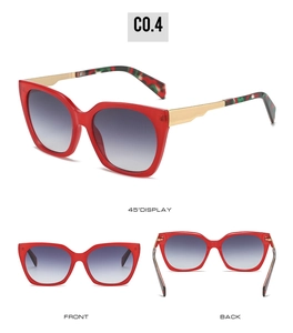 Detail view of red square sunglasses with gradient blue lenses and metal temples