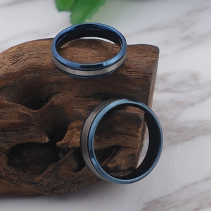 Classic blue and silver titanium steel ring for men with brushed metal finish on wood