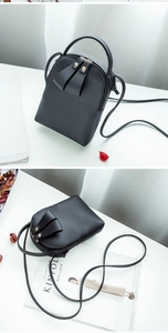Detailed view of black PU leather mini crossbody bag with top handle and zipper pulls