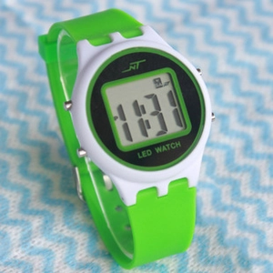 Detailed view of LED watch featuring a green silicone strap and white plastic case