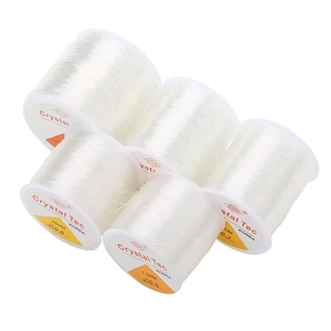 Macro detail of various sizes of transparent elastic crystal beading threads for DIY jewelry