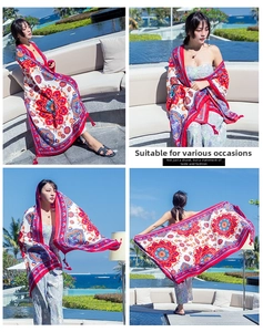 Detail of red bohemian mandala scarf with paisley prints and tassels for beach sun protection