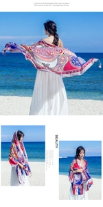 Close-up of bohemian paisley shawl with tassel fringe and colorful ethnic pattern