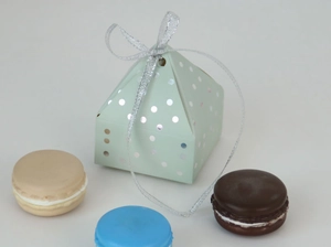 Detail of mint green pyramid gift box with silver foil dots and silver ribbon bow
