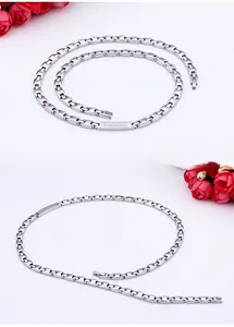 Detailed close-up of polished silver stainless steel link chains with engraved brand plate