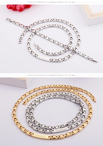 Detail of silver and gold stainless steel bracelets with engraved rectangular logo plates