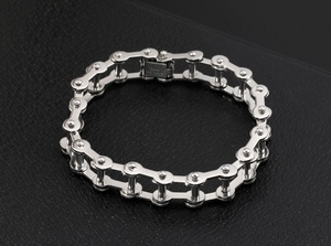 Detailed macro view of silver stainless steel bicycle chain bracelet on black leather