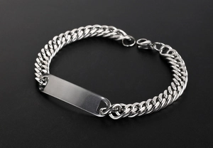 Polished stainless steel Cuban link bracelet with a blank ID plate shown in a macro detail view