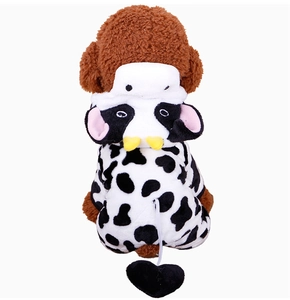 Detail view of plush cow print pet costume with yellow horns and heart tail decoration