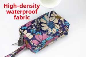 Water test showing high-density waterproof fabric on a floral multi-layer clutch bag